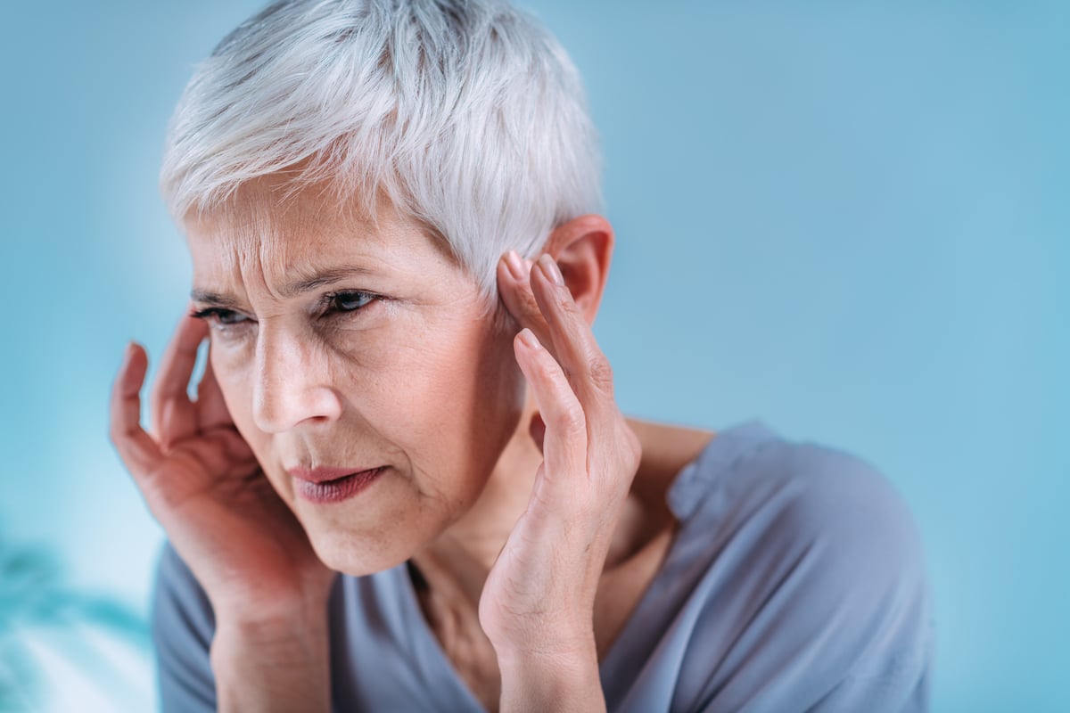 senior woman suffering from tinnitus