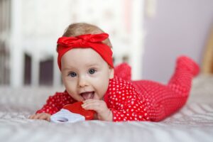 little baby 6 months old in red sleepsuit and head 2022 01 12 00 26 50 utc(1)(2)