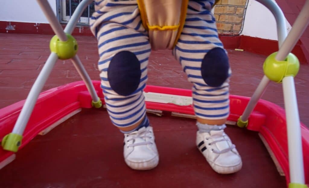 baby sitting in the baby walker during daytime