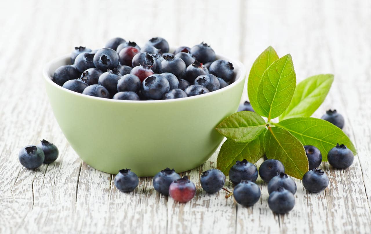 blueberry with leaves on a wooden white board 2022 01 18 23 42 34 utc