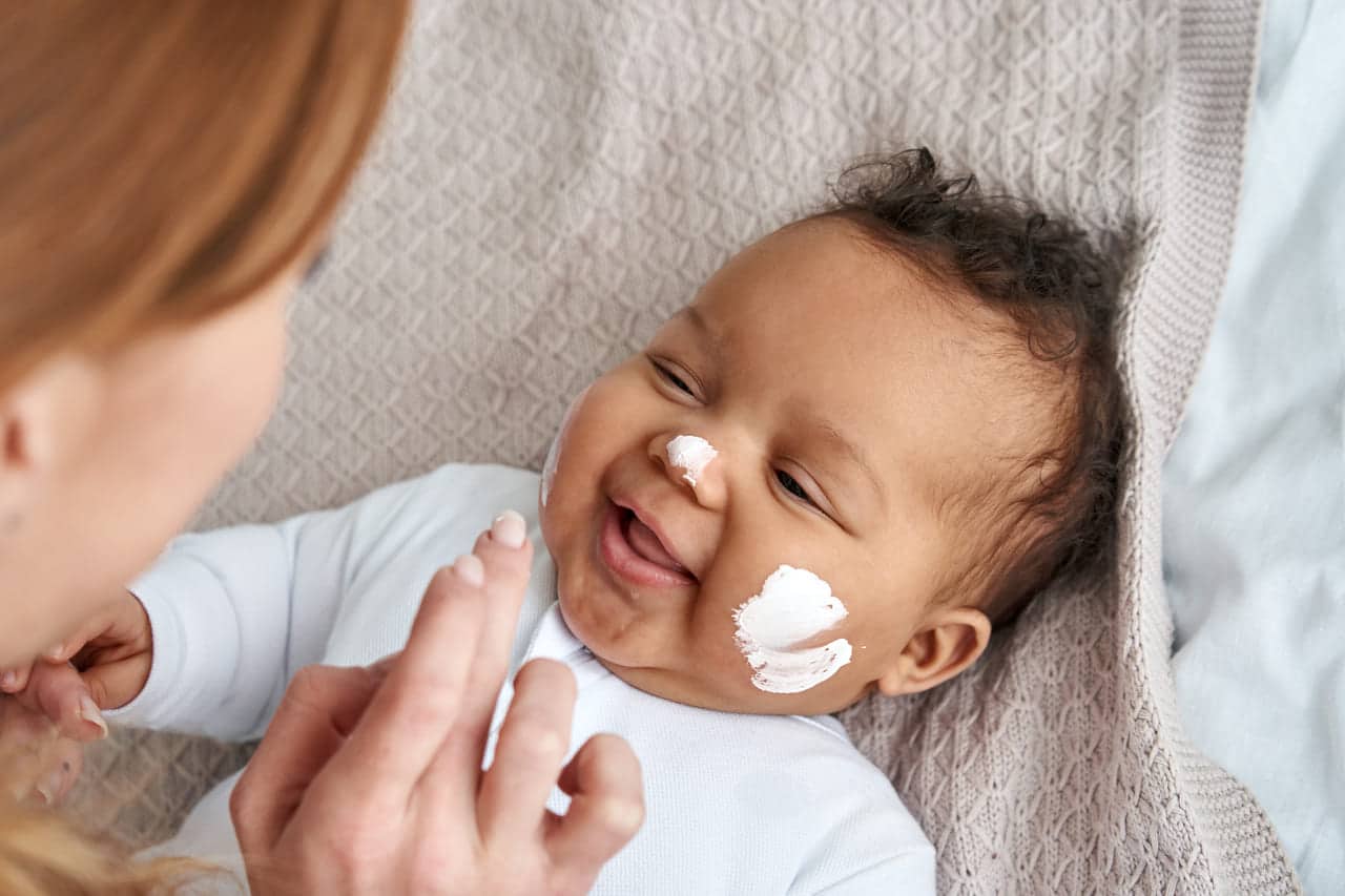 caucasian mother applying skin care cream on cute 2021 09 02 14 46 46 utc