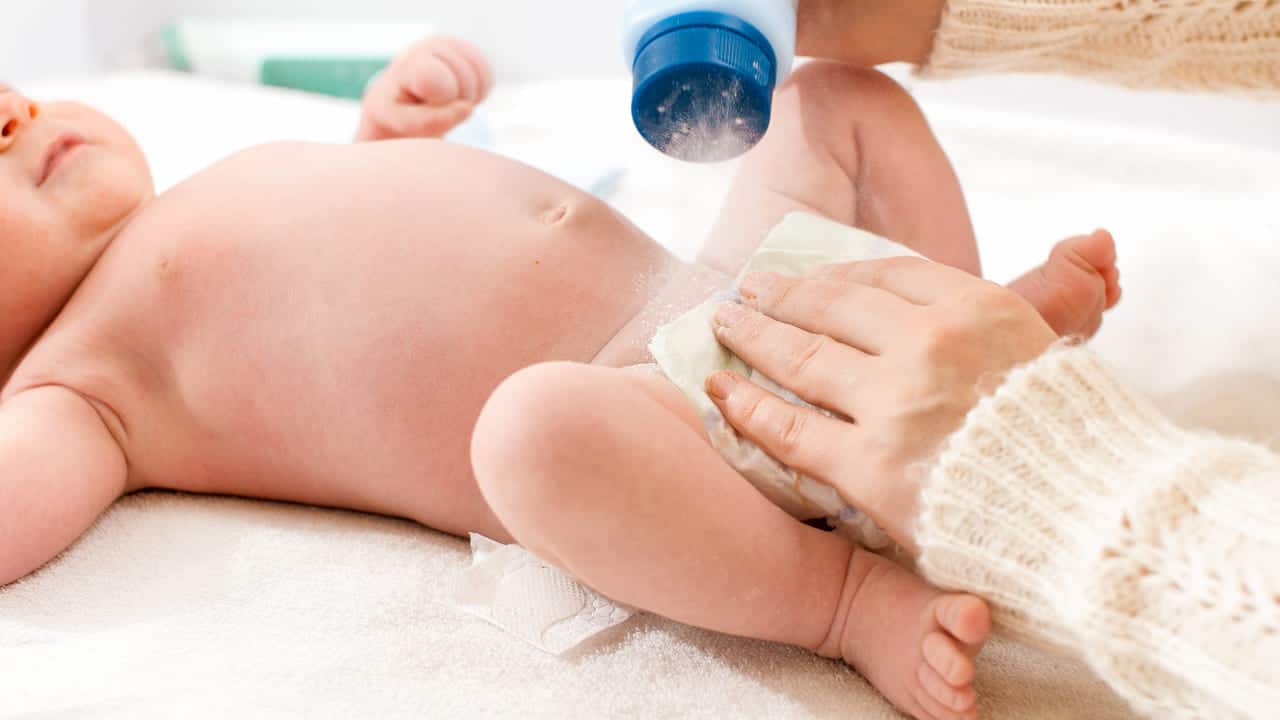 closeup of mother applying talcum powder while cha 2021 12 09 21 21 15 utc