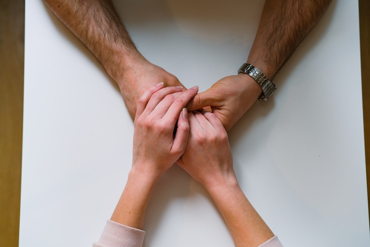 couple holding hands act of love support and kin 2022 11 16 09 05 07 utc(1)