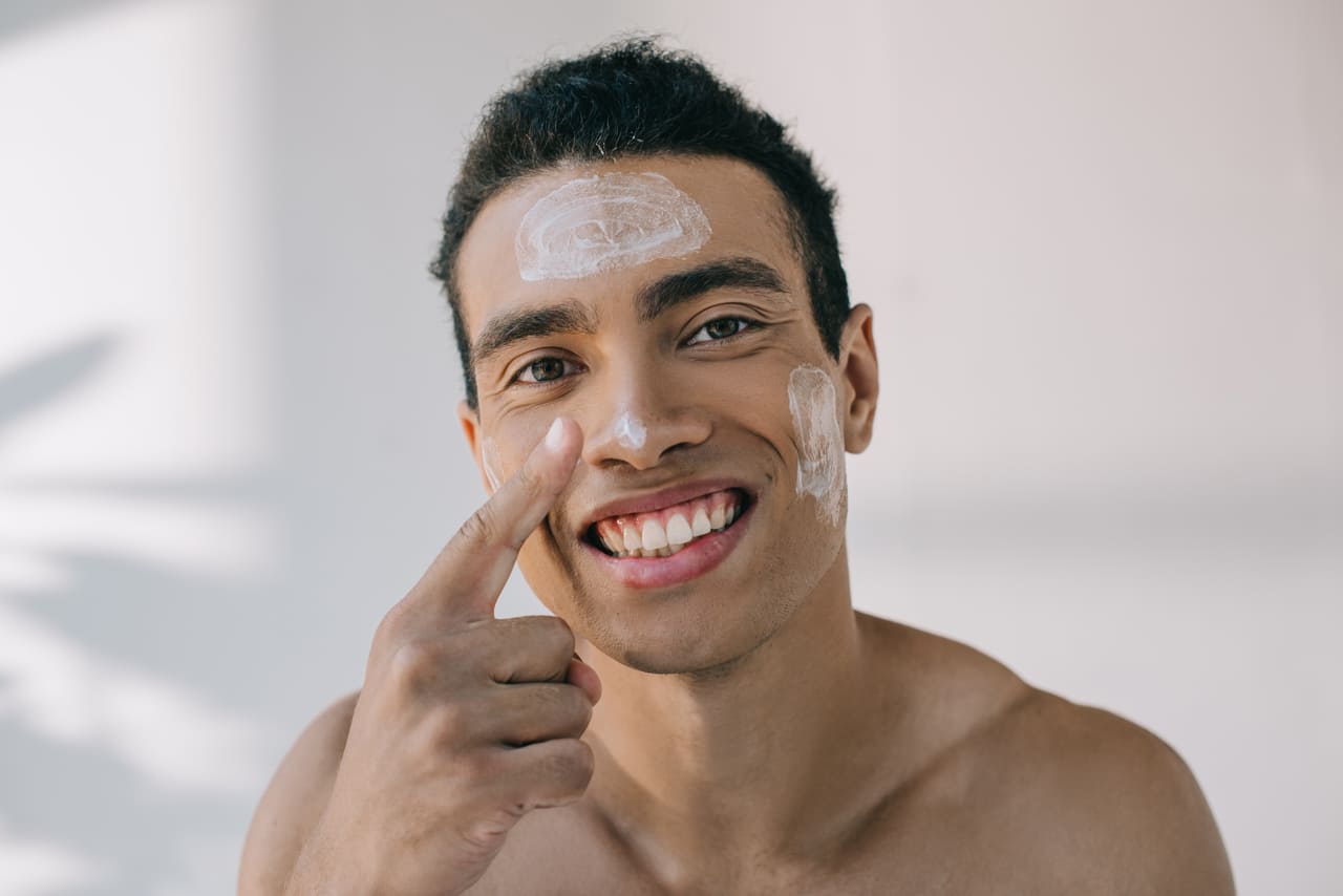 handsome mixed race man applying cosmetic cream on 2022 12 30 02 19 07 utc(1)(1)