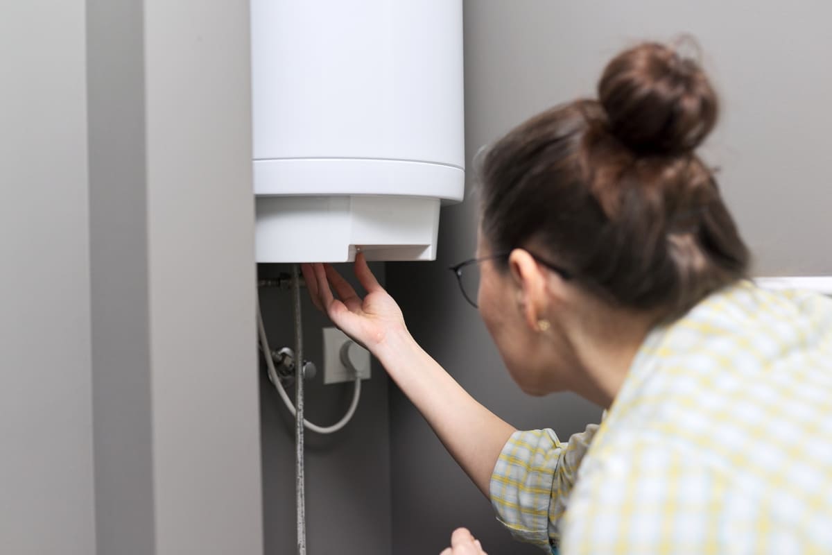 home water heater woman regulates the temperature 2021 12 13 22 28 44 utc(1)(1)