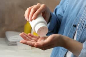 mom applying talc powder from plastic tube baby h 2021 09 02 22 19 27 utc