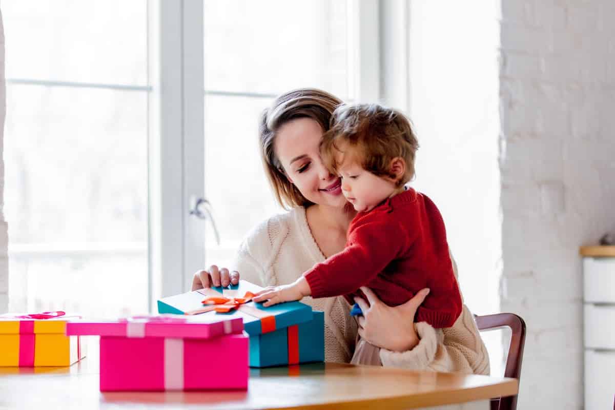 mother and son holding a gift box for christmas 2022 01 12 20 29 14 utc(1)(1)