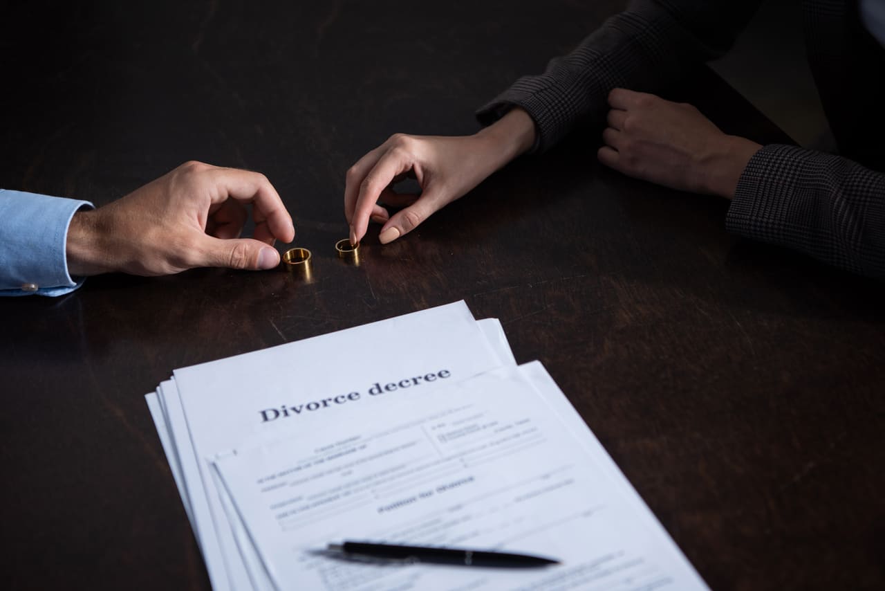 partial view of couple at table with divorce docum 2022 12 16 15 18 52 utc