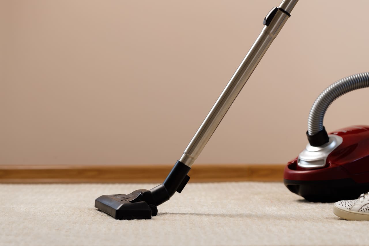 red vacuum cleaner on a beige carpet 2021 09 03 03 02 07 utc