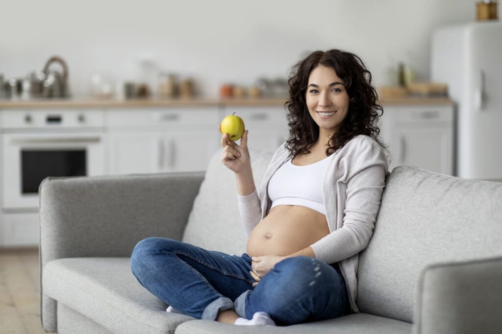 5 months pregnancy diet smiling pregnant woman holding gre 2023 03 08 18 52 45 utc