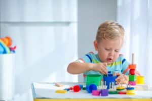 little boy 2 years old is played with a colors toys. educational