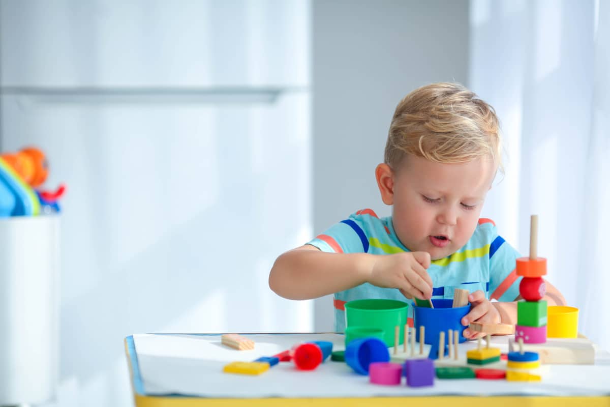 little boy 2 years old is played with a colors toys. educational