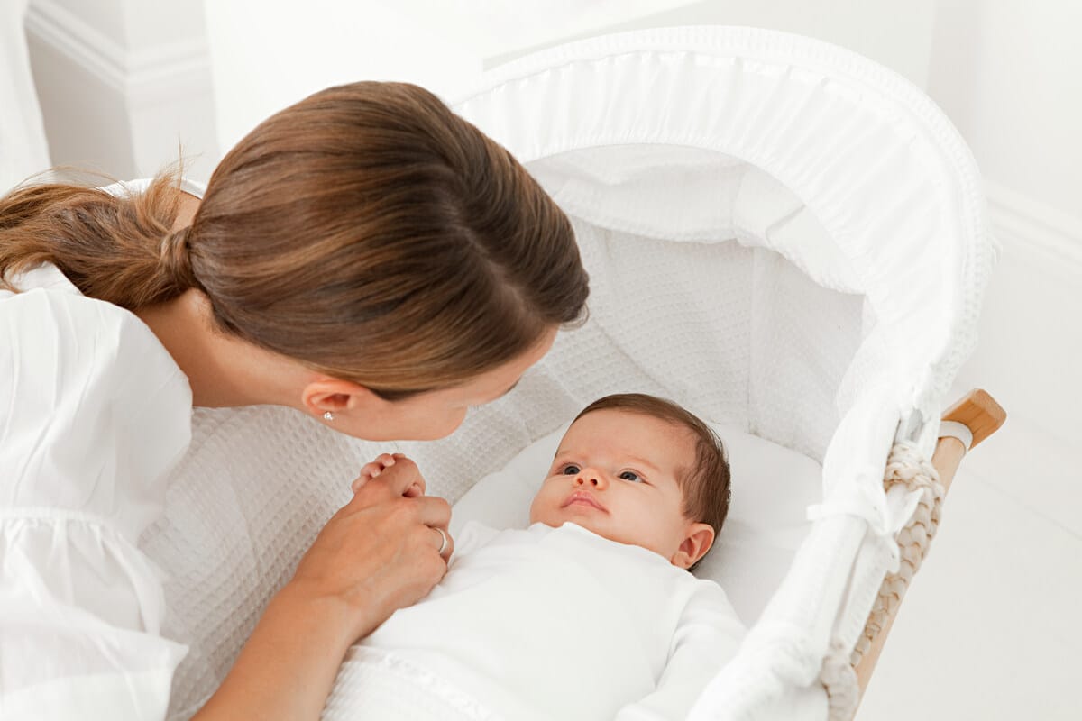 mother with baby in bassinet