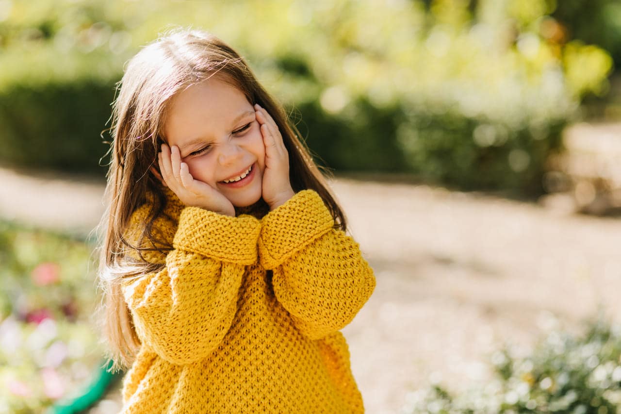 portrait of laughing kid in yellow sweater outdoo 2021 09 02 15 23 53 utc