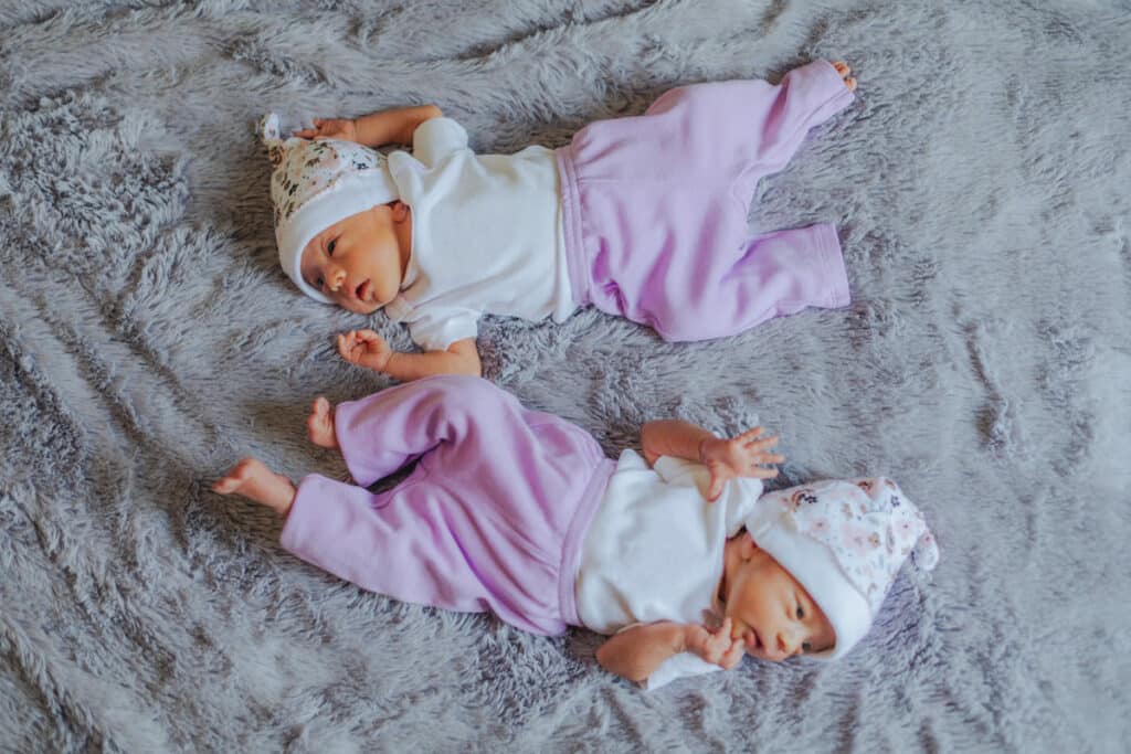 cute newborn twin baby girls laying on a gray blan 2023 11 27 04 50 17 utc(1)(1)