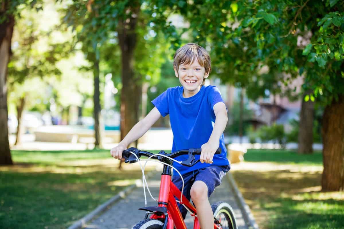 happy young boy riding a bicycle in park 2021 08 29 12 12 06 utc(1)(1)