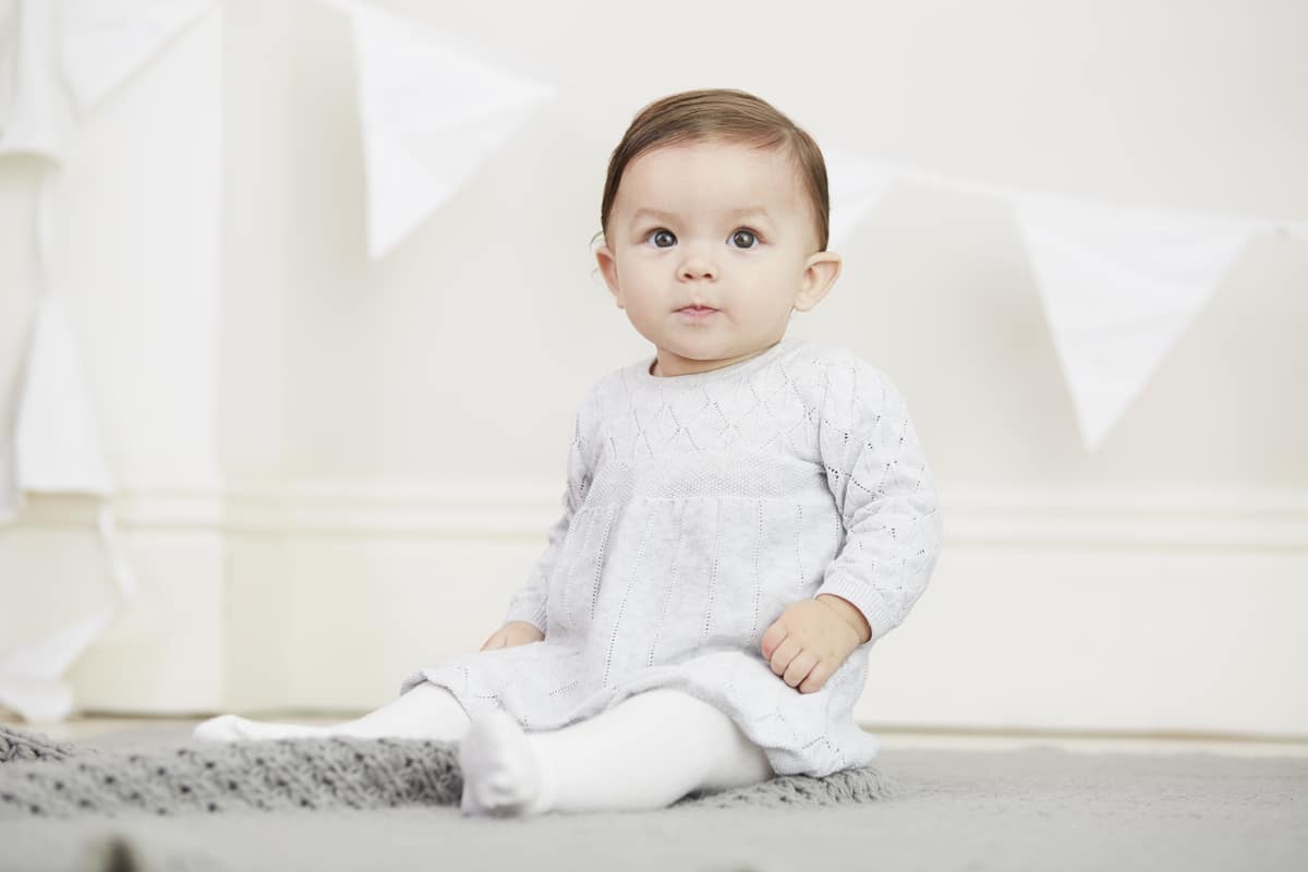 portrait of baby girl, sitting on blanket