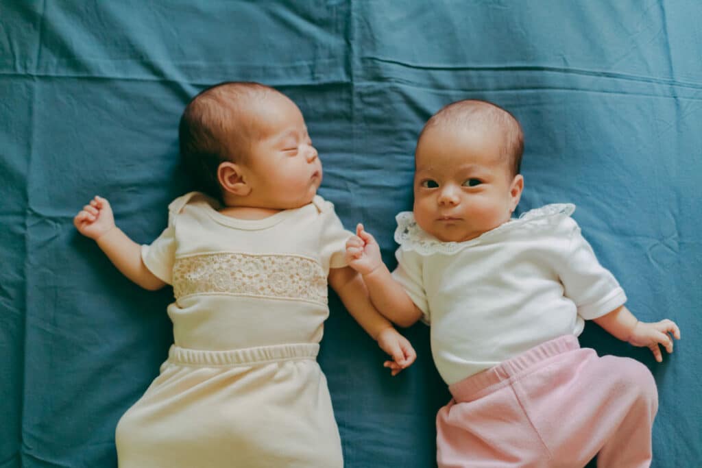 top down view of twin baby girls are lying on a tu 2023 11 27 04 51 30 utc(1)(1)