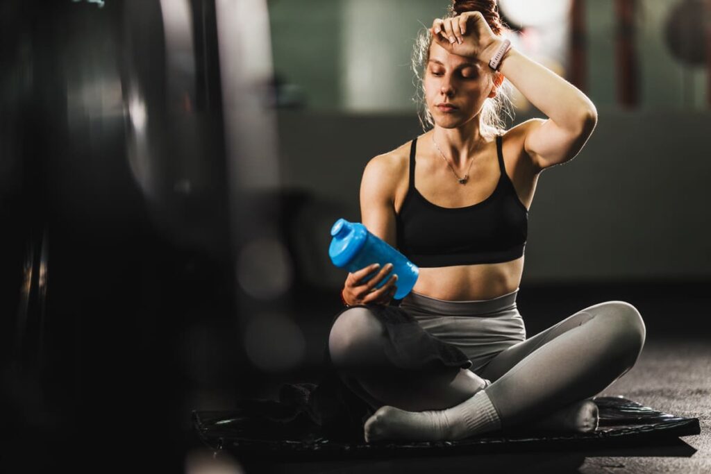 woman holding water bottle before working out at t 2022 12 01 20 02 20 utc(1)(1)