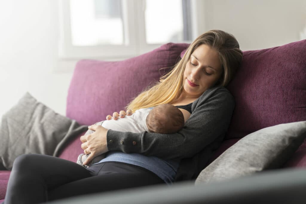young mother on the sofa breastfeeding her newborn 2022 06 29 18 46 40 utc(1)(1)