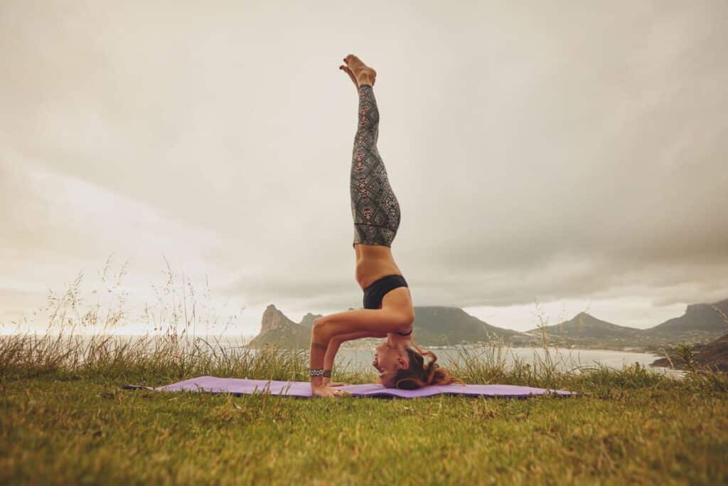 fitness woman practicing headstand yoga outdoors 2023 11 27 05 13 32 utc(1)(1)