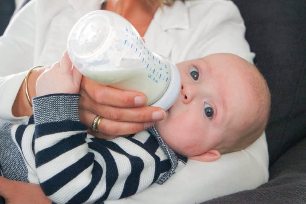 baby drinks milk from the baby bottle and looking 2023 11 27 05 21 50 utc(1)