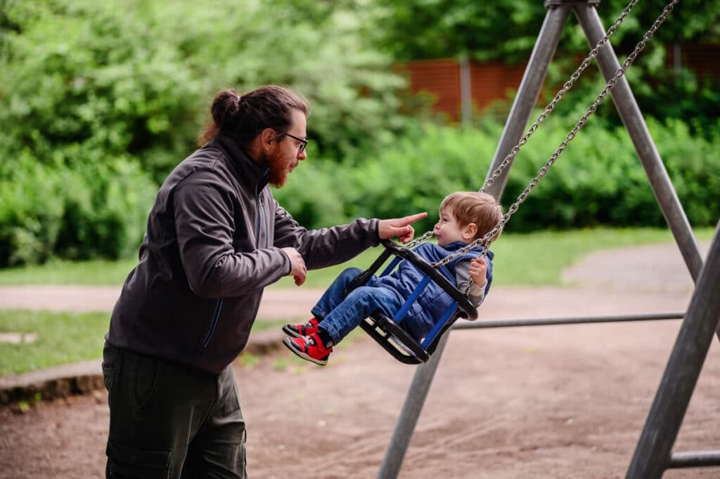 little toddler boy happily rides on swings and pla 2023 11 27 05 03 26 utc(1)(1)(1)