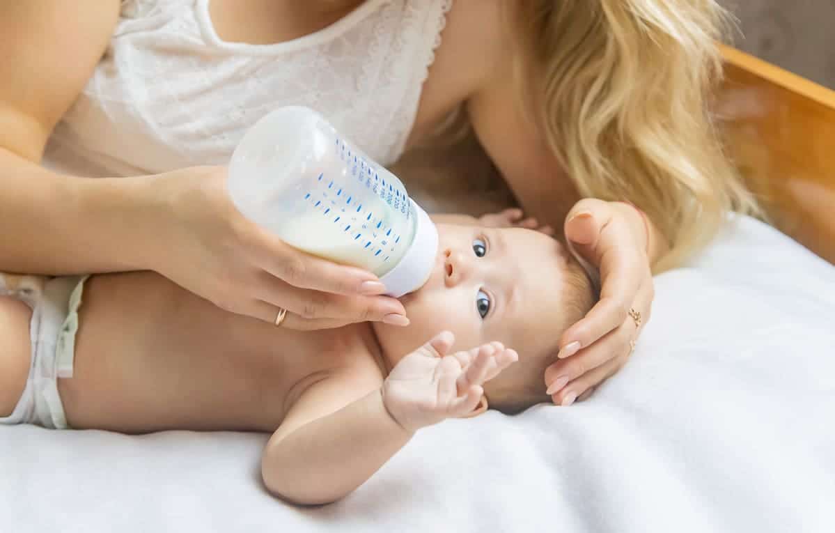 mom feeds the baby with a bottle selective focus 2023 11 27 05 25 33 utc(1)(1)