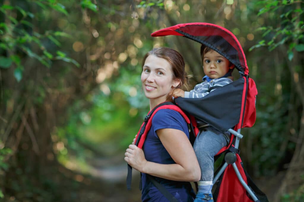 mother with toddler child in backpack carrier is h 2023 11 27 05 07 50 utc(1)(1)