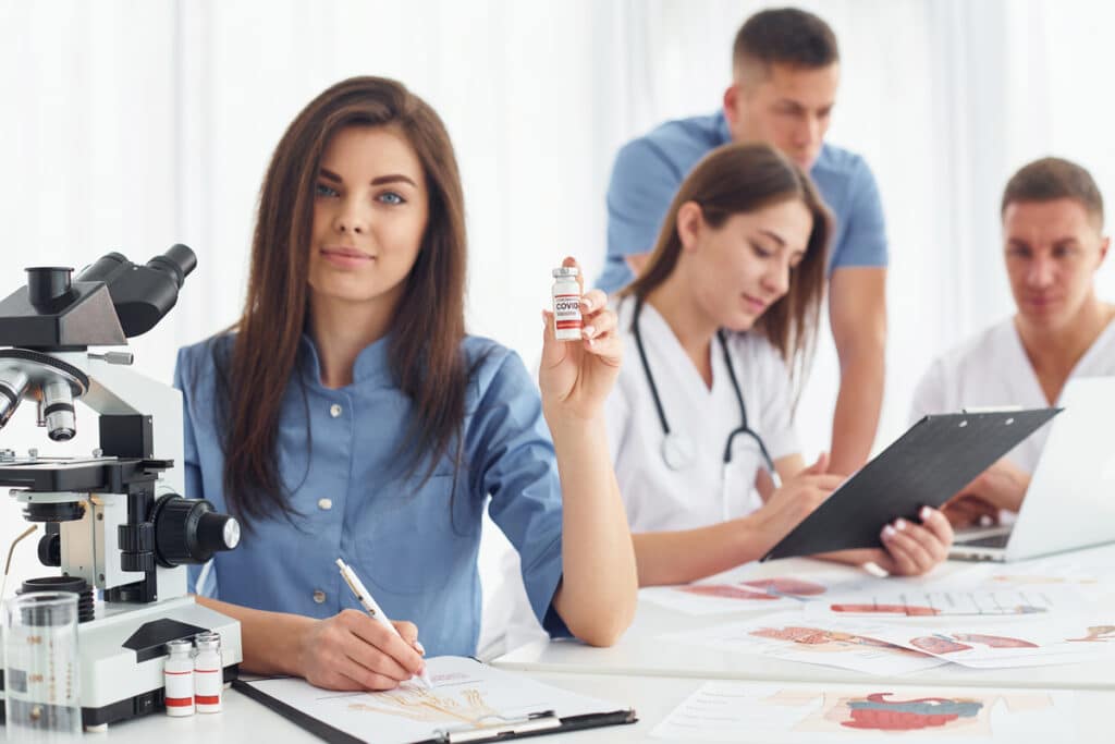 woman works with document. group of young doctors is together in the office