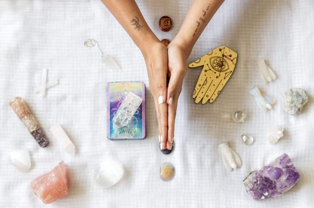 flat lay of a woman s hands praying over tarot car 2023 11 27 05 25 02 utc(1)