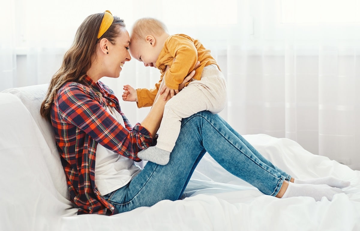 mother child baby having fun family happy childhood care cheerful cute boy sun