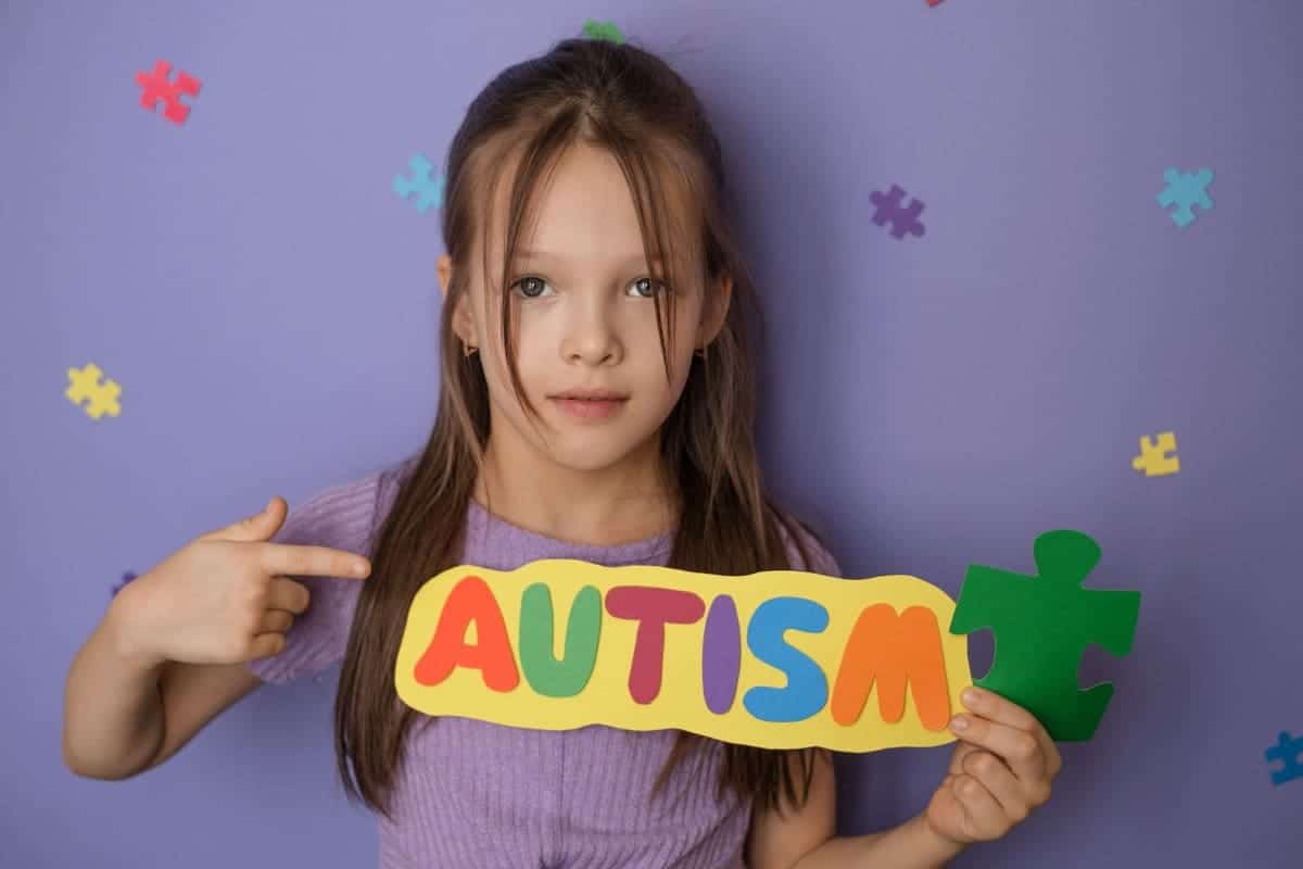 young girl holding sign in front of backdrop 2026 03 05 11 49 46 utc(1)